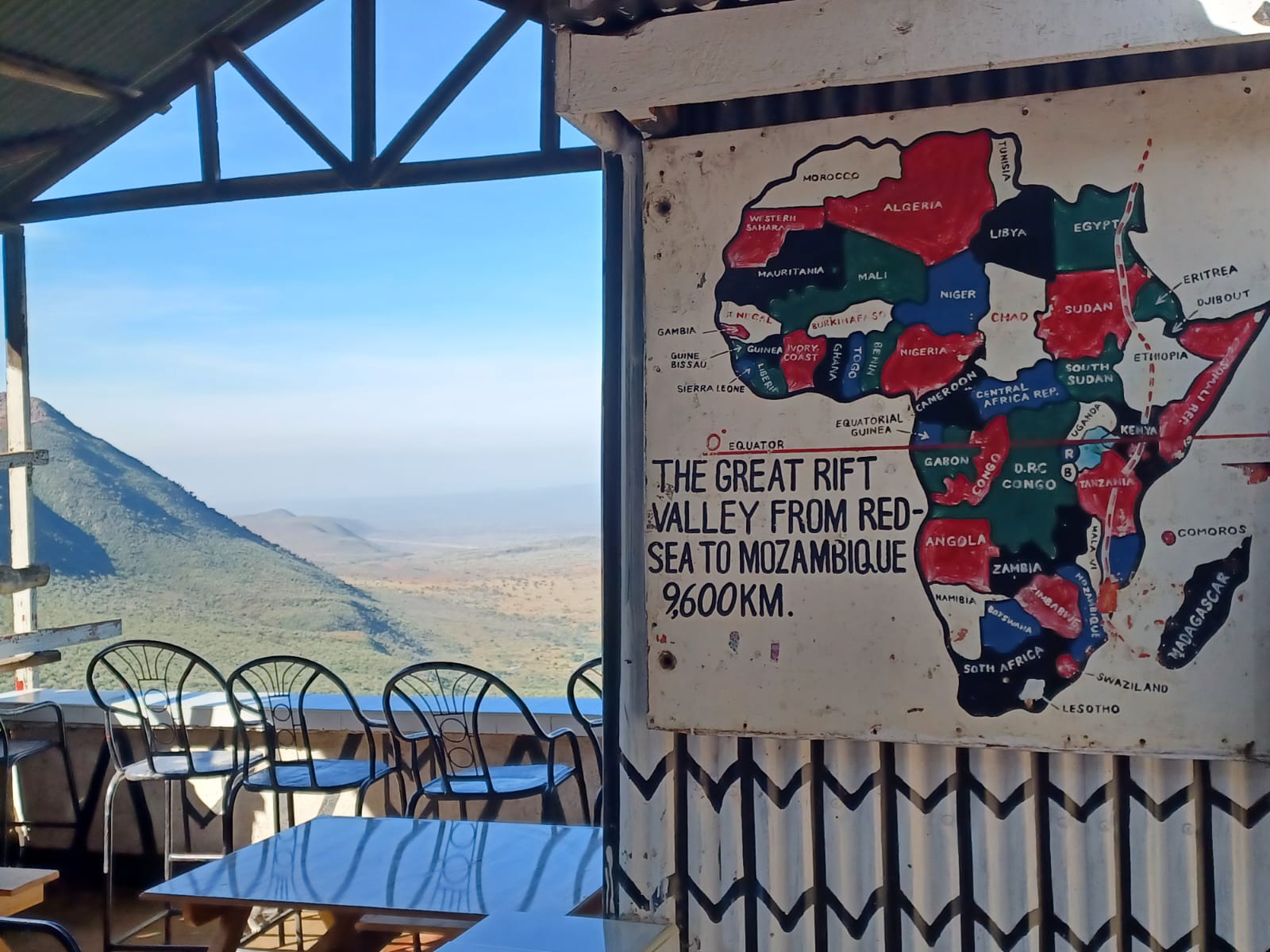 A viewpoint terrace above the Great Rift Valley in Kenya, beside a hand-painted map of the rift